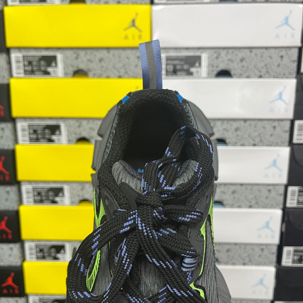 Balenciaga sneaker heel close-up with black mesh, neon green highlights, and blue laces