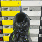 Balenciaga sneaker heel close-up with black mesh, neon green highlights, and blue laces