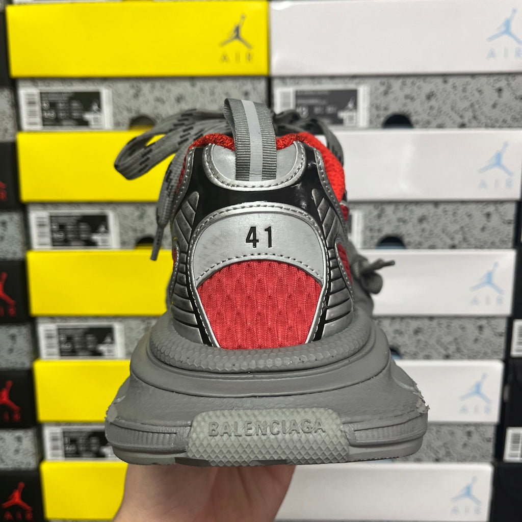 Back view of sneaker with red heel panel and gray midsole, lace-up