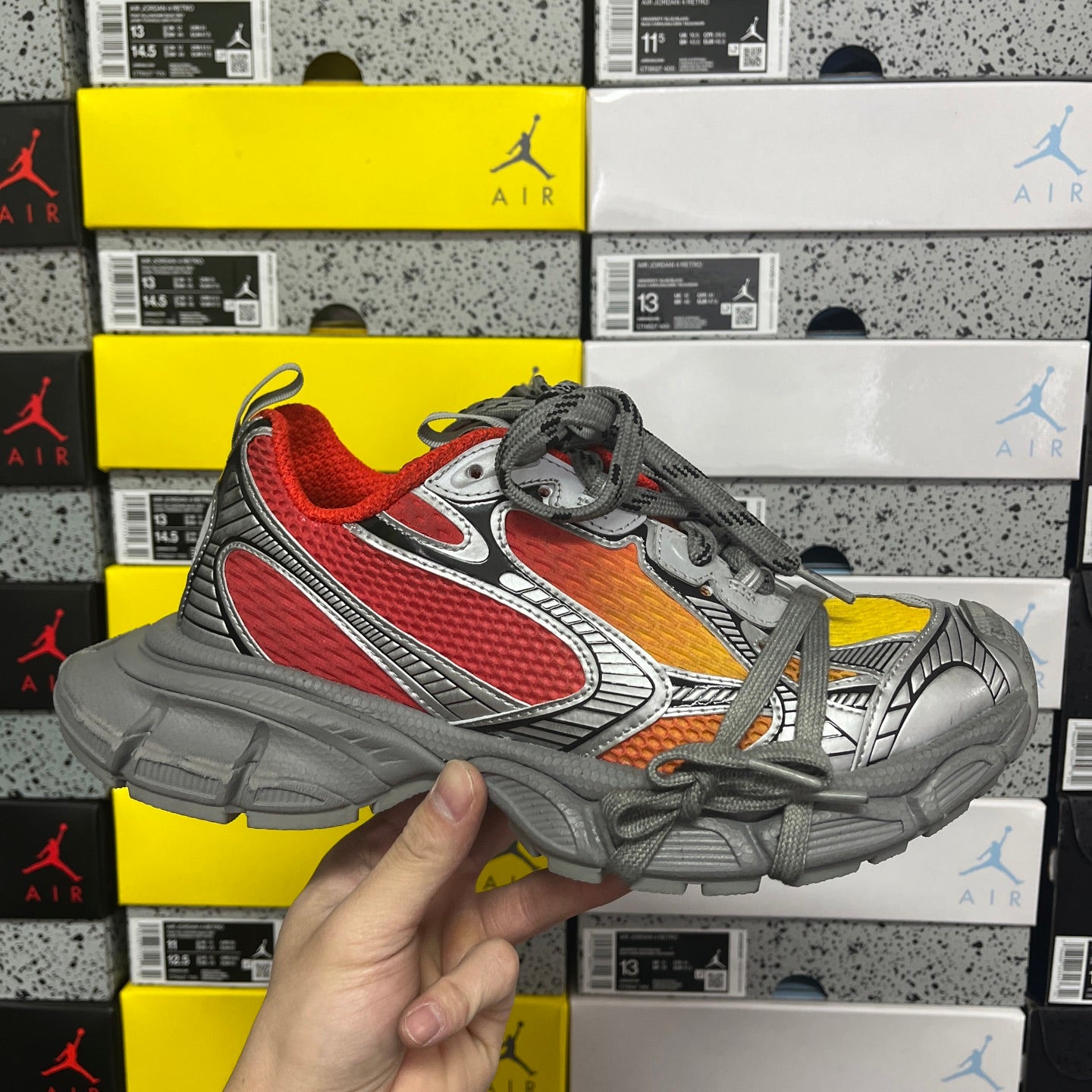 Low-top sneakers with red mesh panels, gray leather, and gray laces