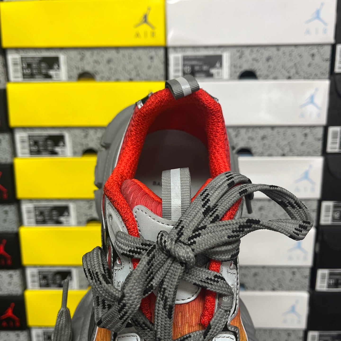 Sneaker heel and opening with red lining and gray laces