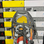 Sneaker toe and laces with red, orange, and yellow panels on a gray upper