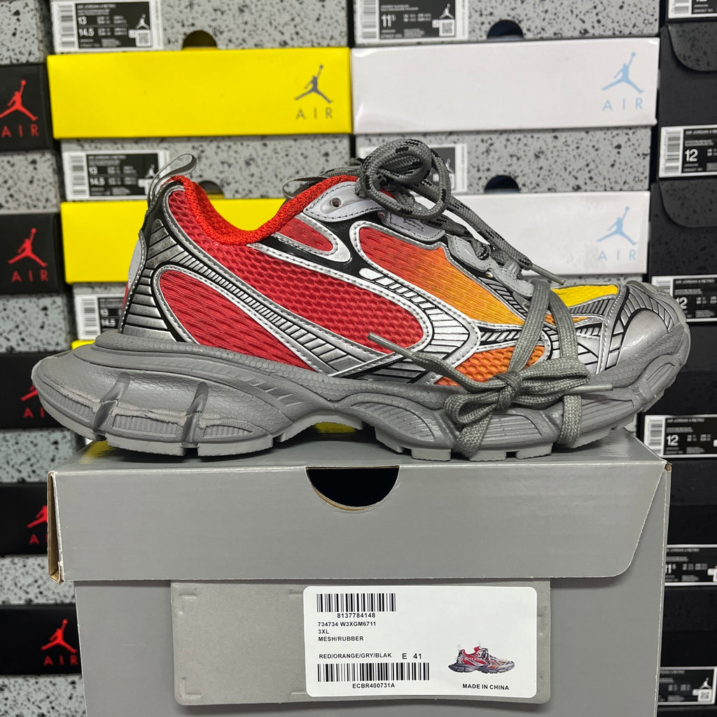 Chunky low-top sneakers in gray with red and orange accents, laced