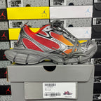 Chunky low-top sneakers in gray with red and orange accents, laced