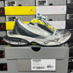 Side profile running sneaker in grey and black with neon yellow detail and blue striped laces