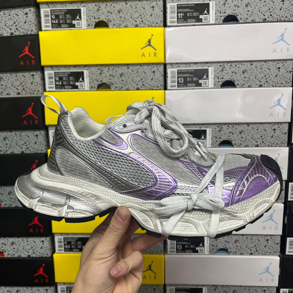 Unisex running shoe with silver mesh upper and purple swoosh-style logo