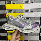 Unisex running shoe with silver mesh upper and purple swoosh-style logo