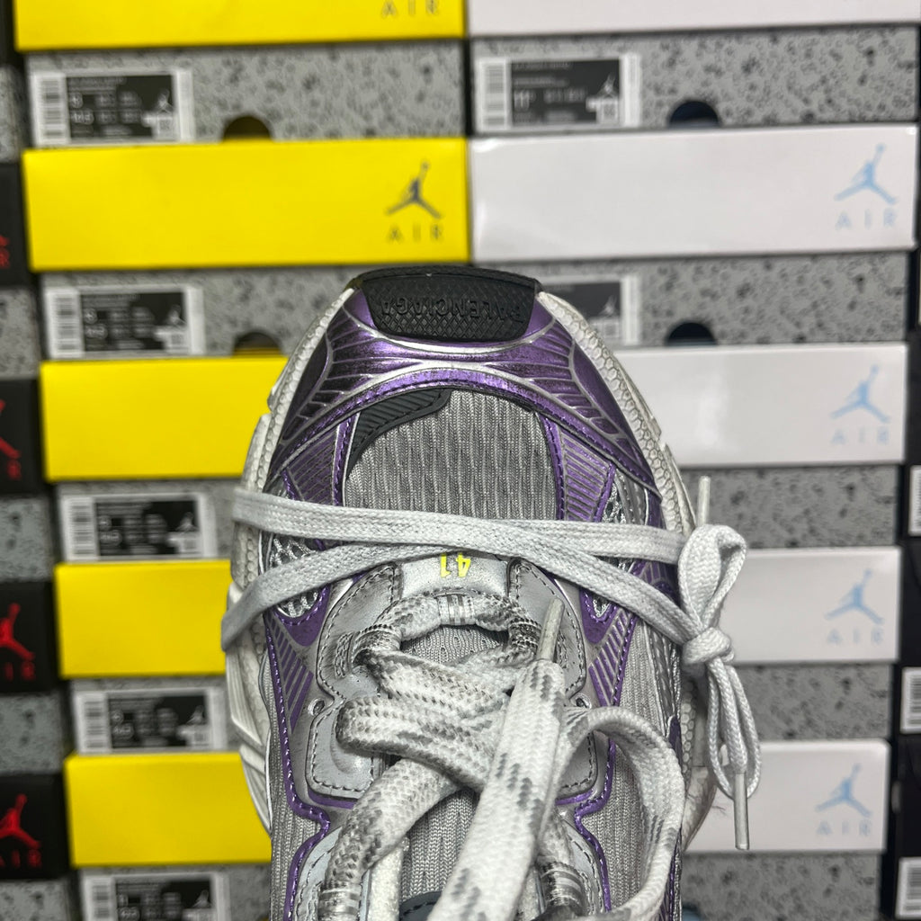 Unisex running shoe close-up, purple and silver mesh tongue with gray lace-up