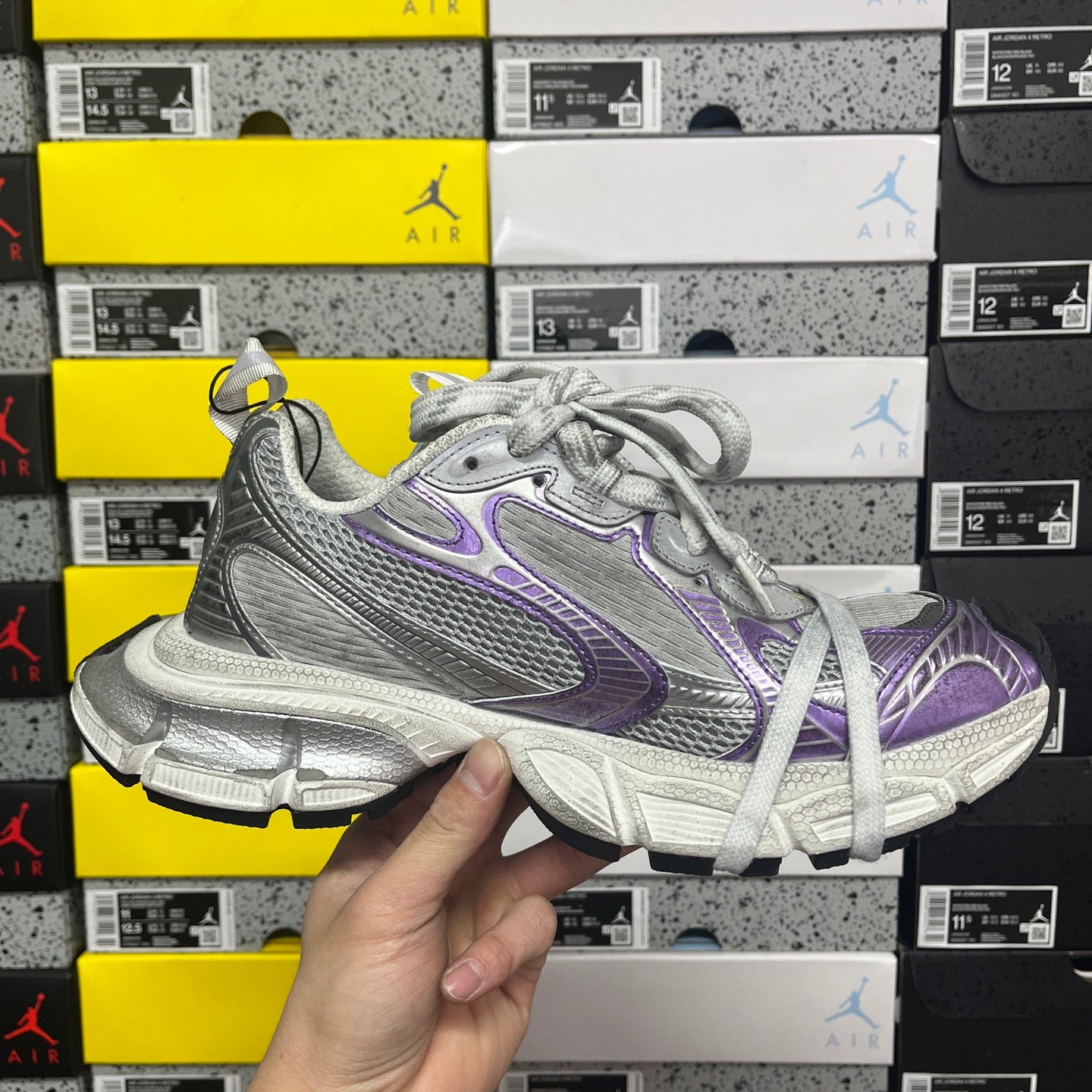 Unisex running shoe front view, silver mesh with purple logos and white laces