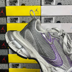 Unisex running shoe heel and midsole view, metallic silver with purple accents