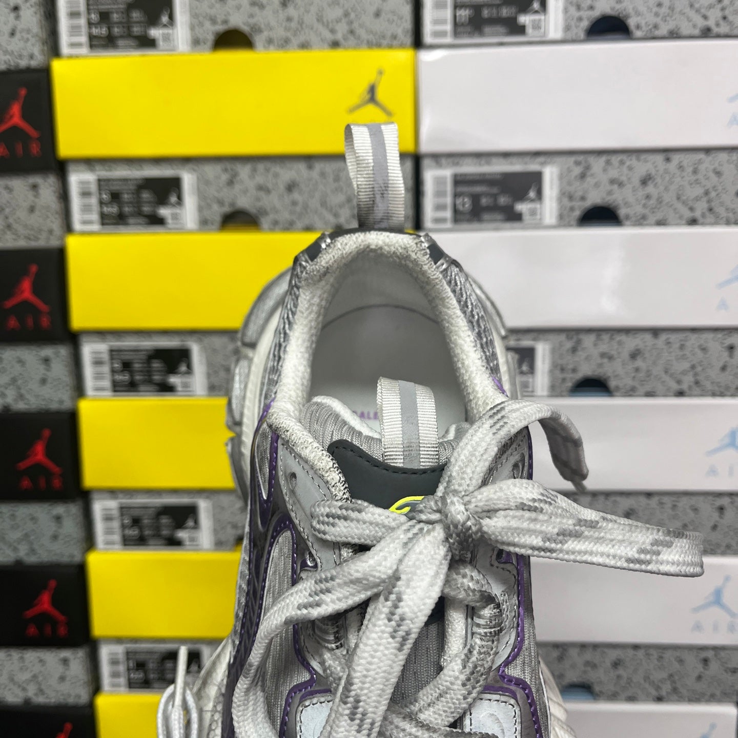 Unisex running shoe collar and tongue view, gray laces and silver upper