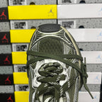 Green and silver sneaker upper detail with lace-up front and patterned overlays