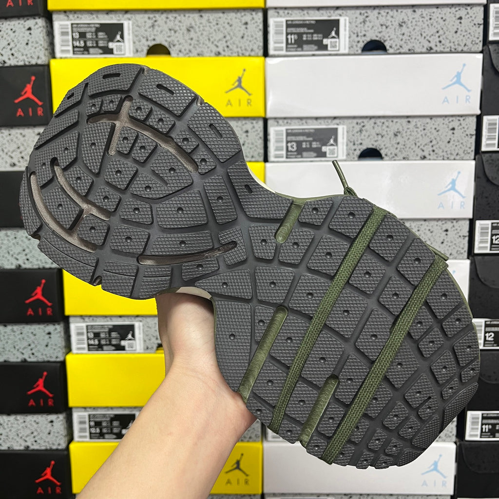 Green and gray sneaker outsole with raised tread and thick rubber sole