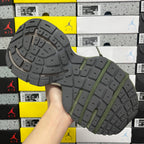 Green and gray sneaker outsole with raised tread and thick rubber sole