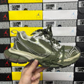 Green and silver sport sneakers with green laces and textured mesh panels