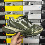 Green and silver sport sneakers with green laces and textured mesh panels