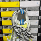 Silver sneaker collar with white laces, blue striped pull tab, neon lime logo detail.