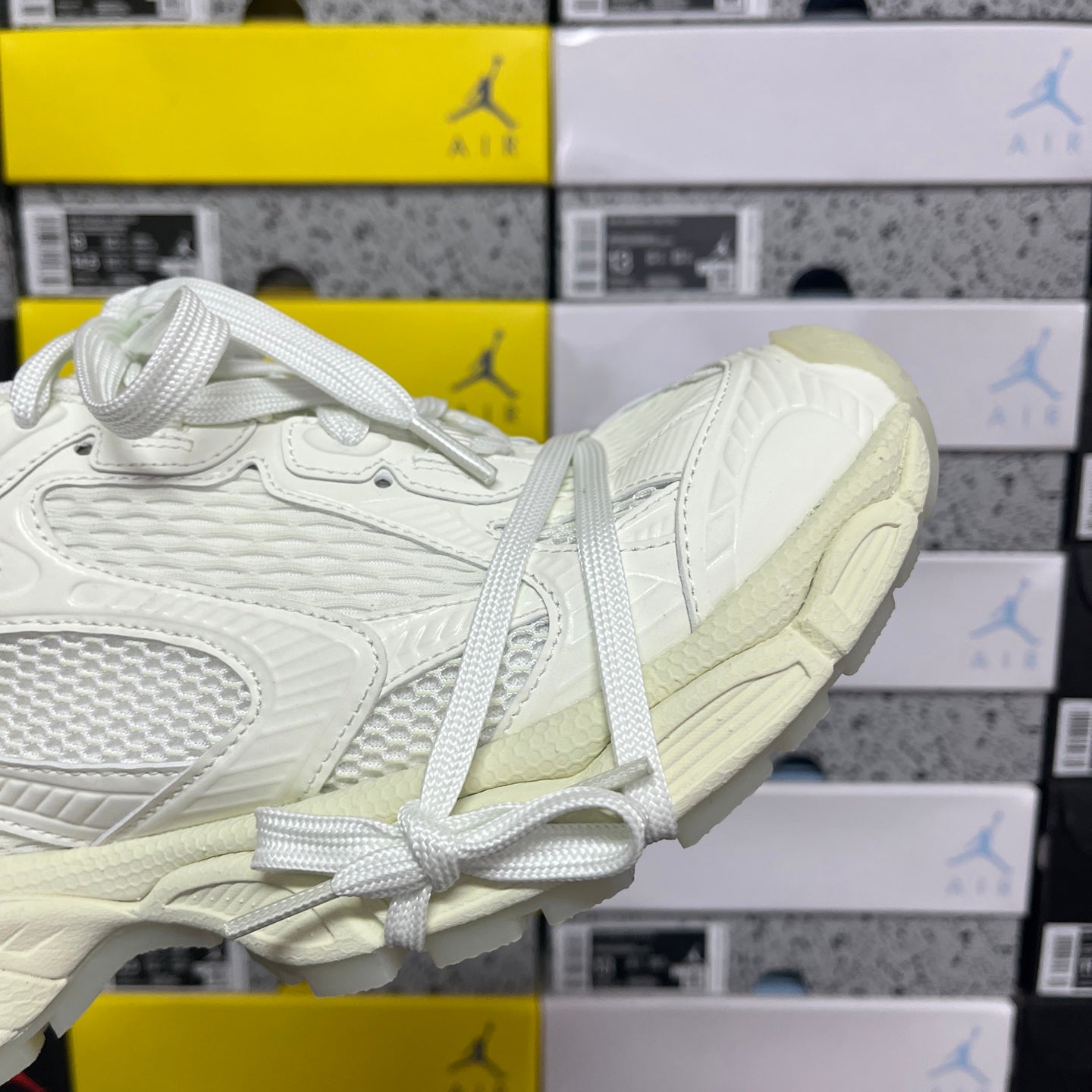 Balenciaga unisex sneakers angled toe and side, white upper with lace-up front