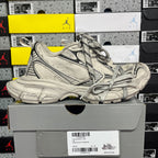 Light gray chunky sneakers with black trim, lace-up front, and thick molded sole