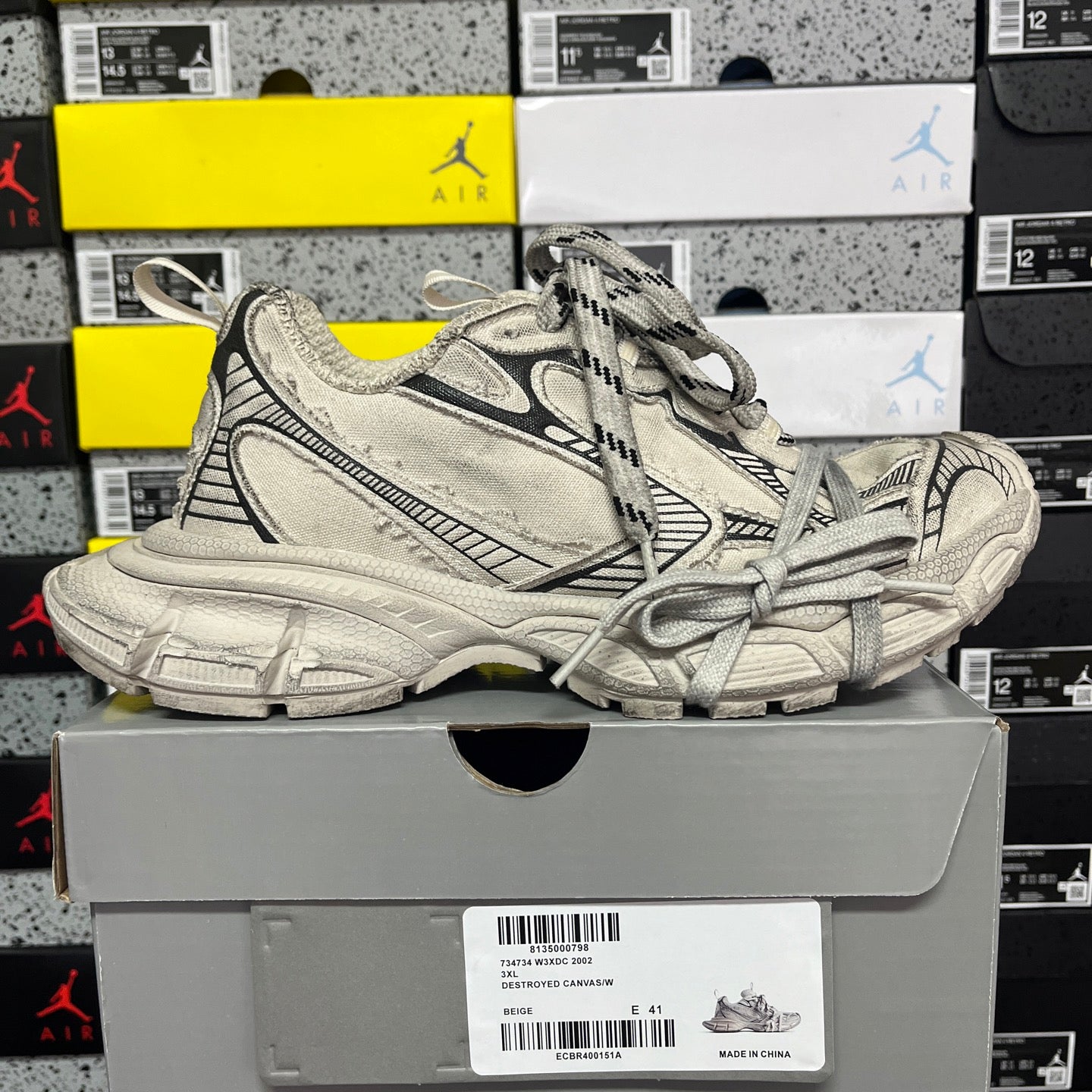 Light gray chunky sneakers with black trim, lace-up front, and thick molded sole