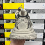 Light gray sneaker heel with logo patch and textured rear collar, back view