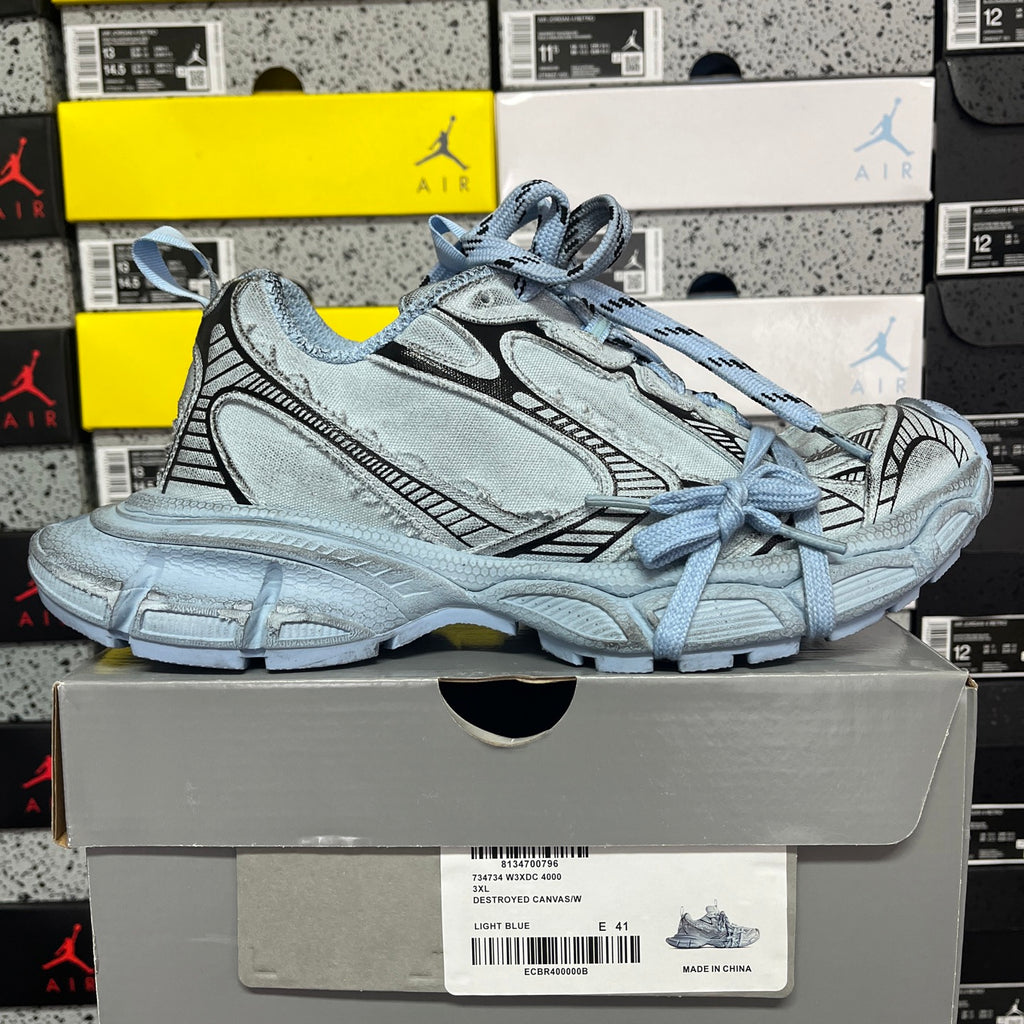 Light blue lace-up sneakers with stitched overlays and padded collar, chunky outsole
