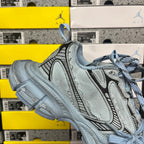 Light blue lace-up sneaker with embossed texture, side logo stripe, chunky sole