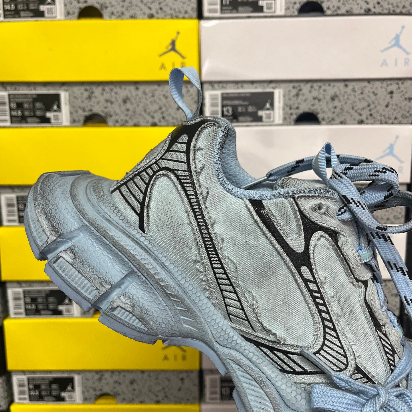 Light blue lace-up sneaker with embossed texture, side logo stripe, chunky sole