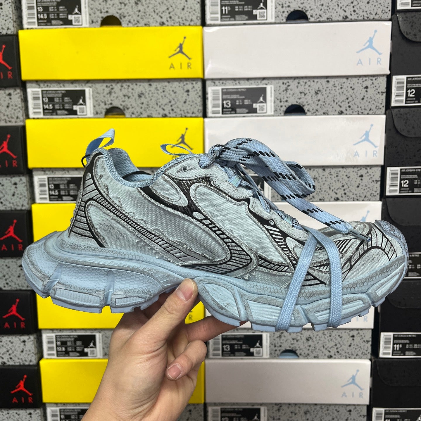 Light blue lace-up sneakers, side profile with signature overlay details