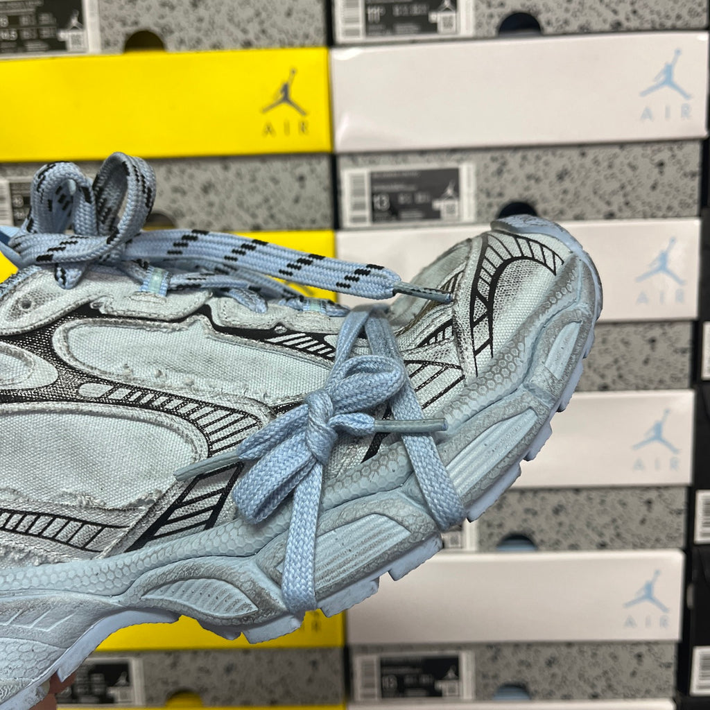 Light blue sneakers side view with lace-up closure and sculpted midsole