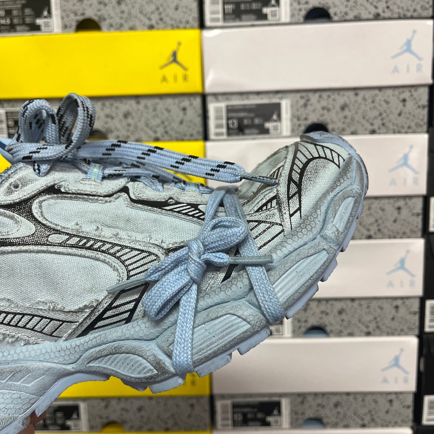 Light blue sneakers side view with lace-up closure and sculpted midsole