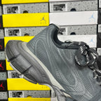 Gray lace-up running shoe with textured knit upper and white side accent