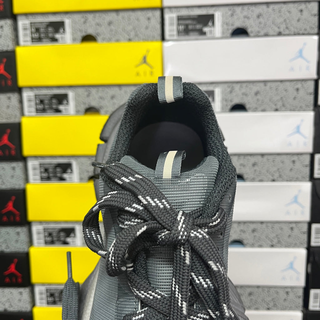 Gray knit shoe heel with pull tab and patterned black-and-white laces