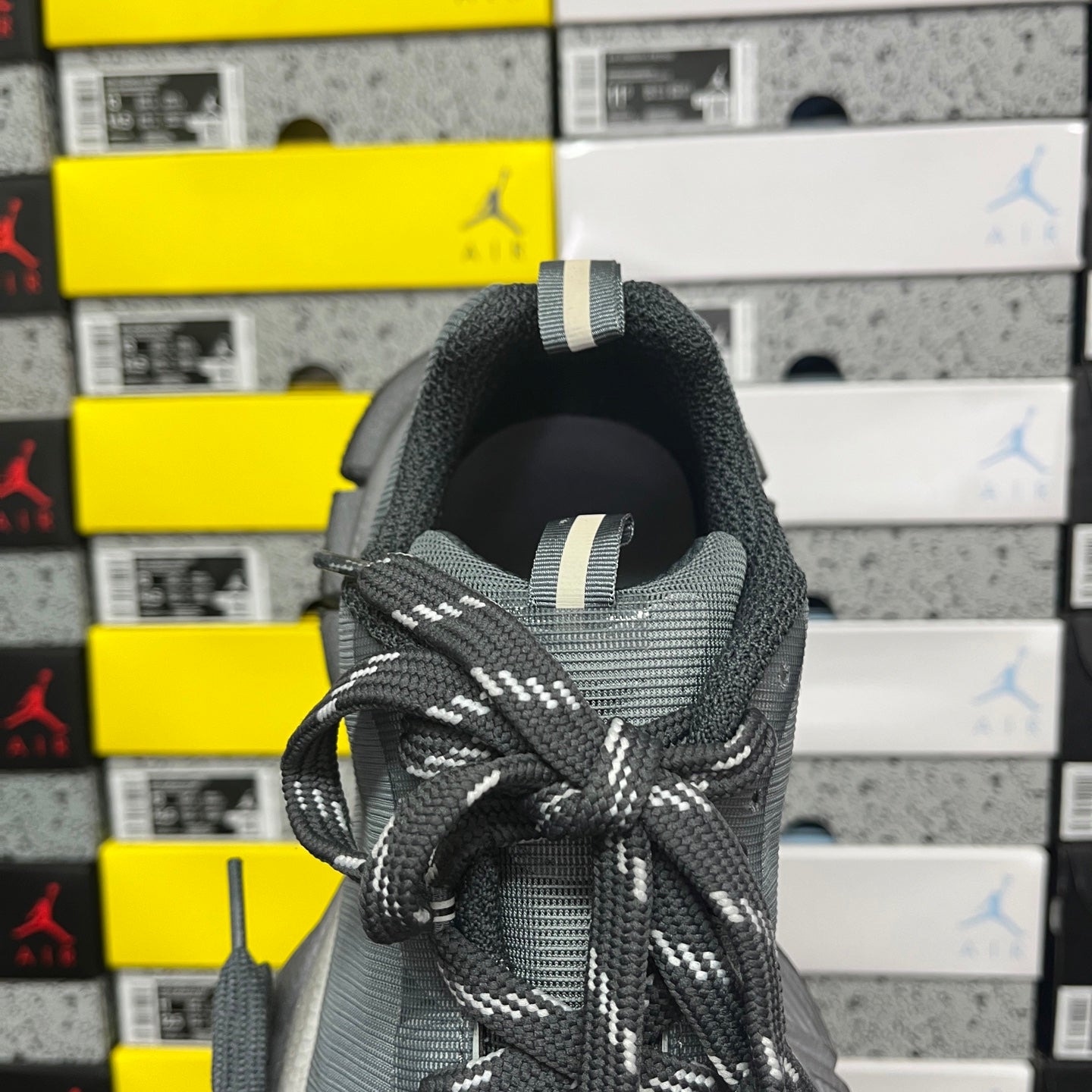 Gray knit shoe heel with pull tab and patterned black-and-white laces