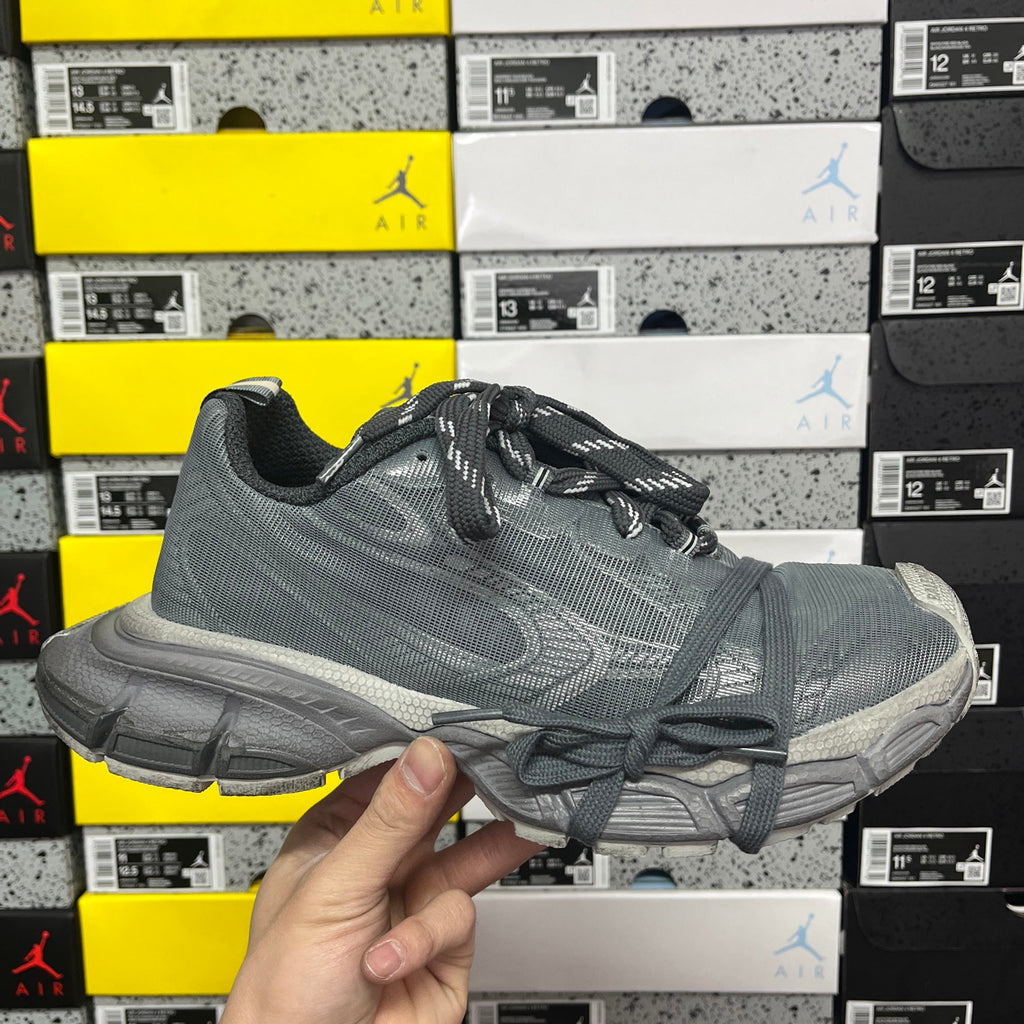 Gray lace-up athletic shoe with textured upper and thick rubber sole