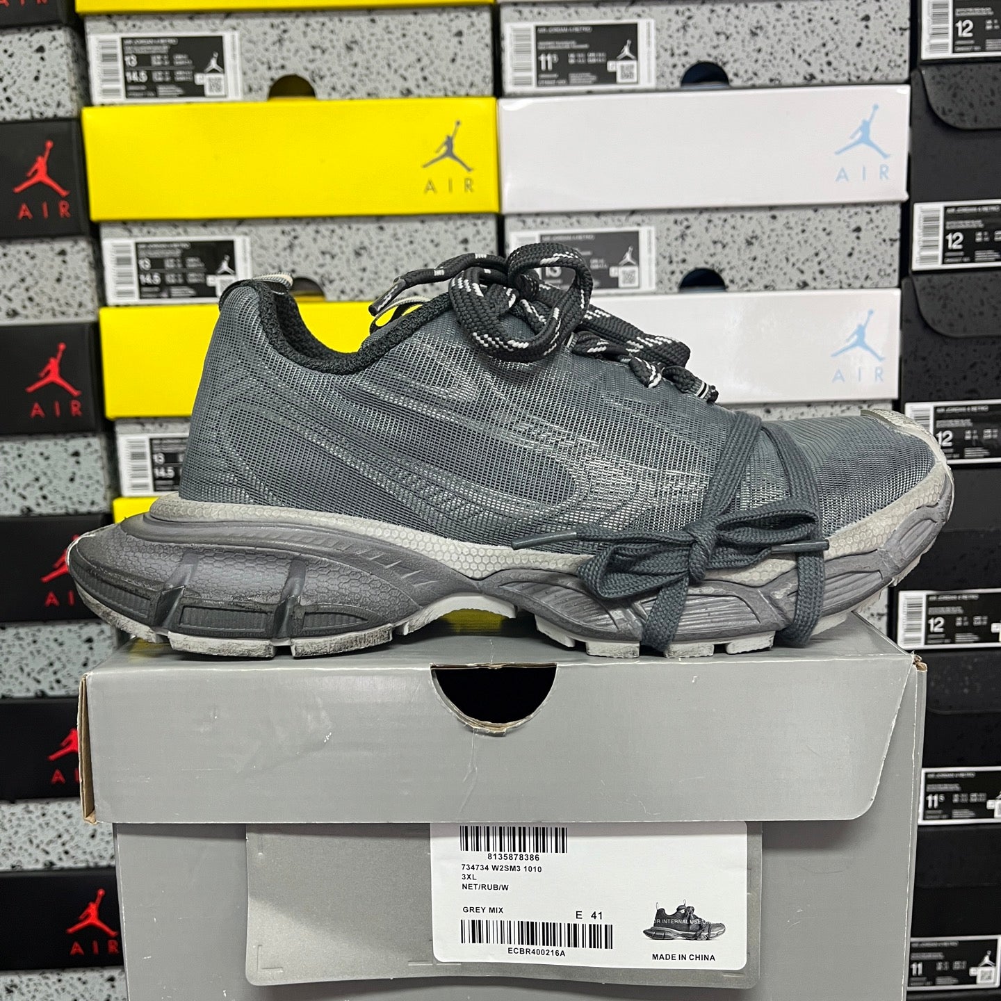 Gray lace-up athletic sneaker with side logo detail and cushioned midsole