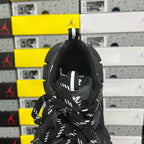 Black sneaker heel and lace area with fabric pull tab and stitched logo detail