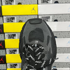 Black knit sneaker tongue with circular Under Armour logo and Balenciaga lace area