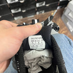 Black knit sneaker interior tongue label with size information and “BALENCIAGA” text