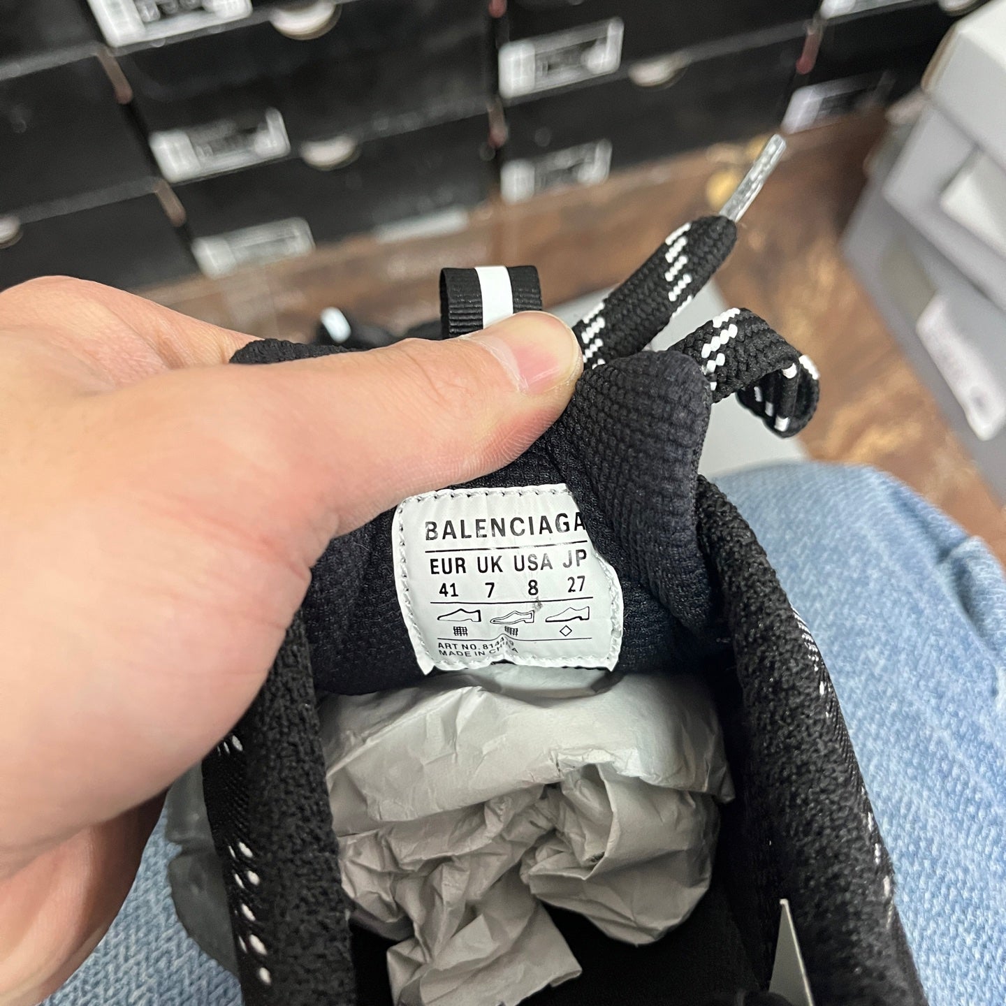 Black knit sneaker interior tongue label with size information and “BALENCIAGA” text
