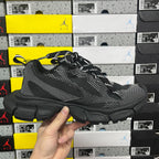 Black lace-up knit sneaker front-quarter view with chunky rubber sole and side logo