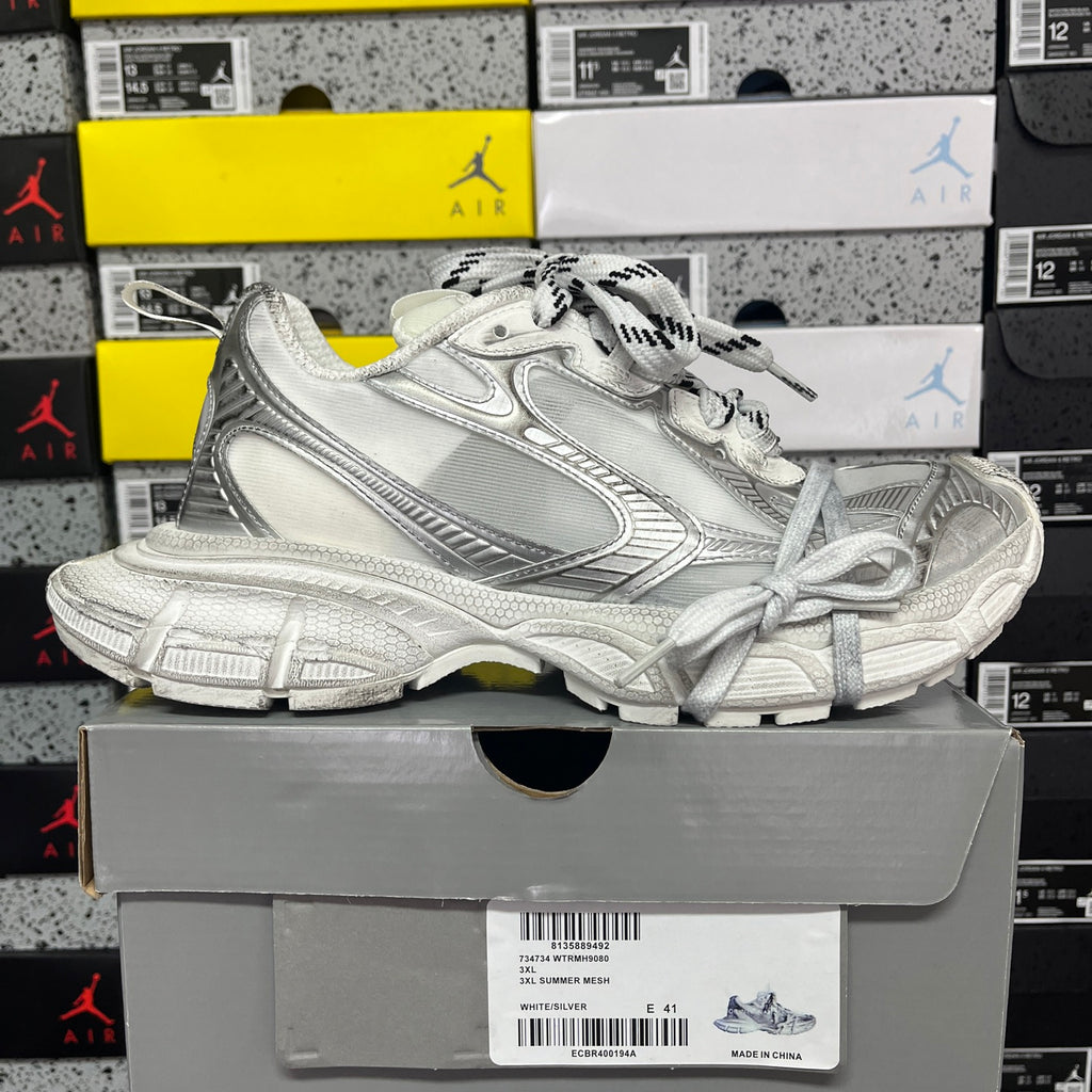 Balenciaga unisex silver lace-up sneakers on a shoebox, side view
