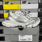 Balenciaga unisex silver lace-up sneakers on a shoebox, side view