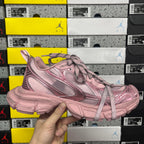Balenciaga unisex sneaker angled side view in pink with lace-up and layered sole.