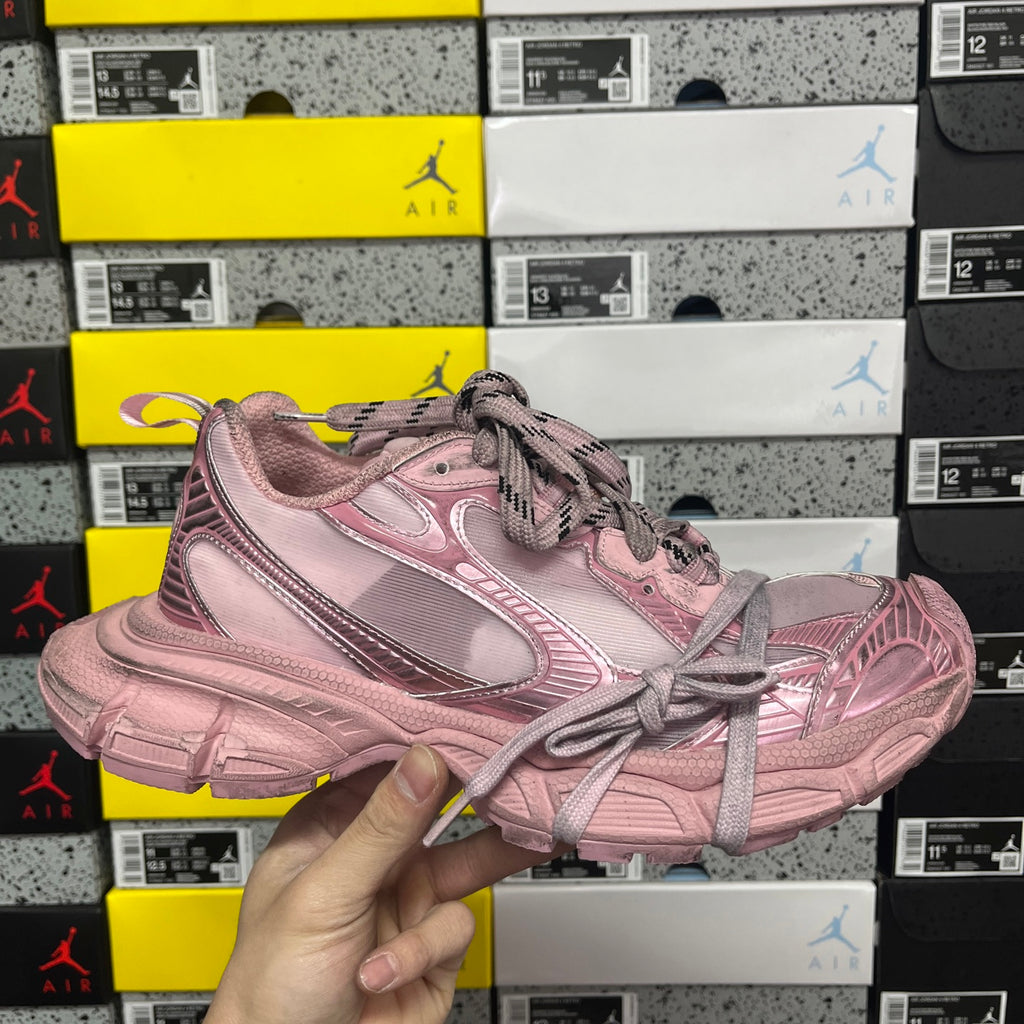 Balenciaga unisex sneaker in pink with lace-up front and metallic-look stripe detail.
