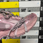Balenciaga unisex sneaker side view in pink with lace-up ties and panel stripes.