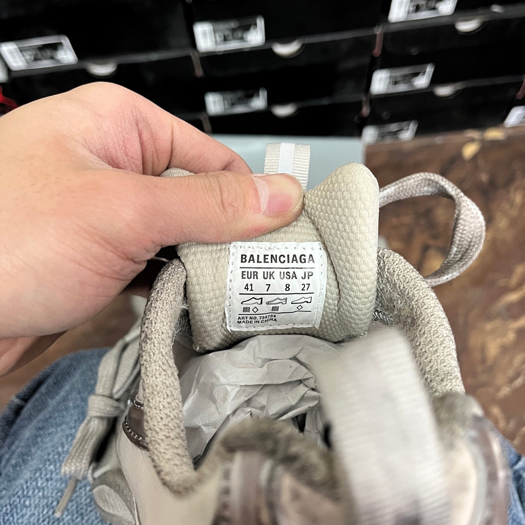 Balenciaga unisex sneaker tongue label with size info in gray fabric.