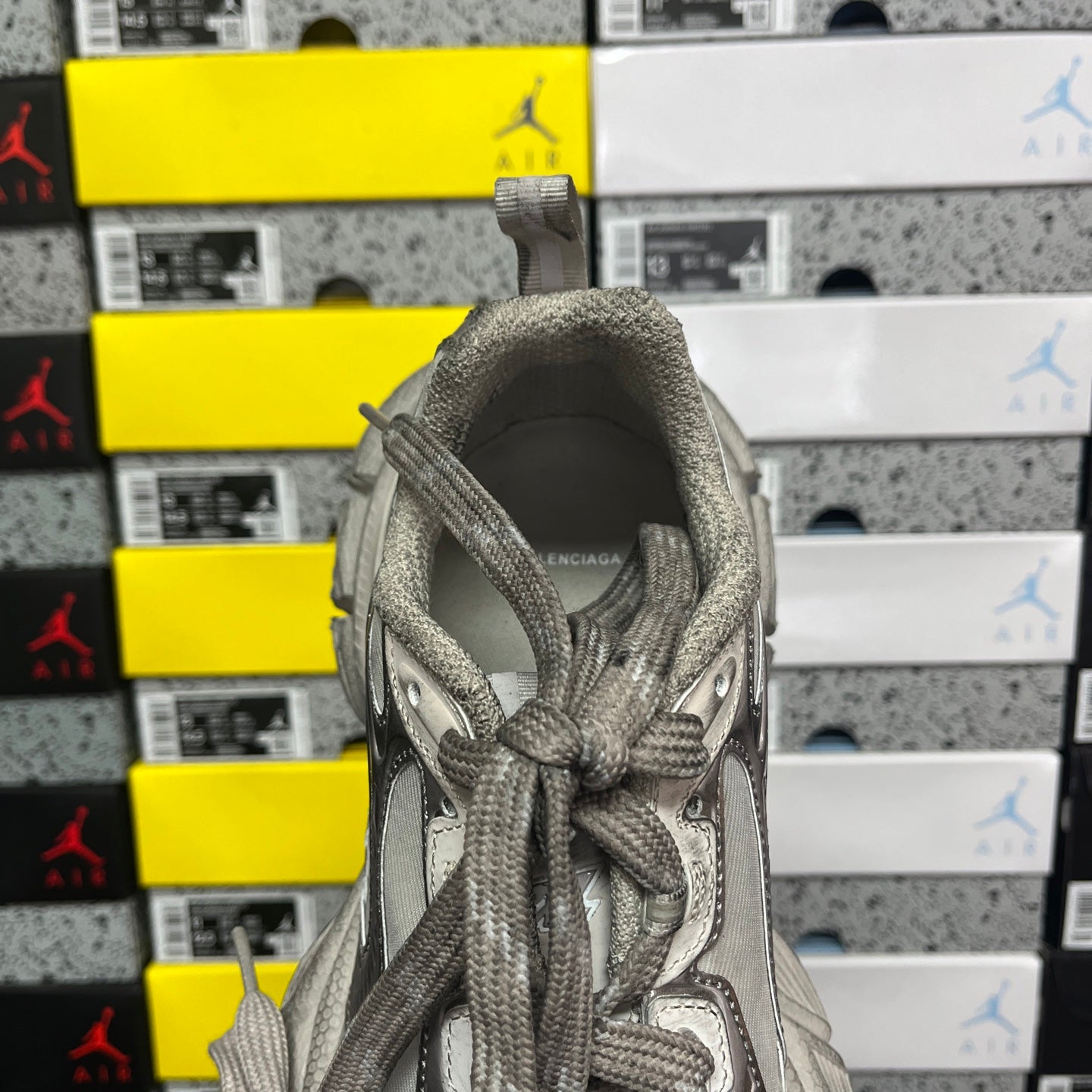 Balenciaga unisex gray sneaker heel view with laces tied and rear panel.