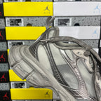 Balenciaga unisex gray low-top sneaker with lace-up front and metallic panel detailing.