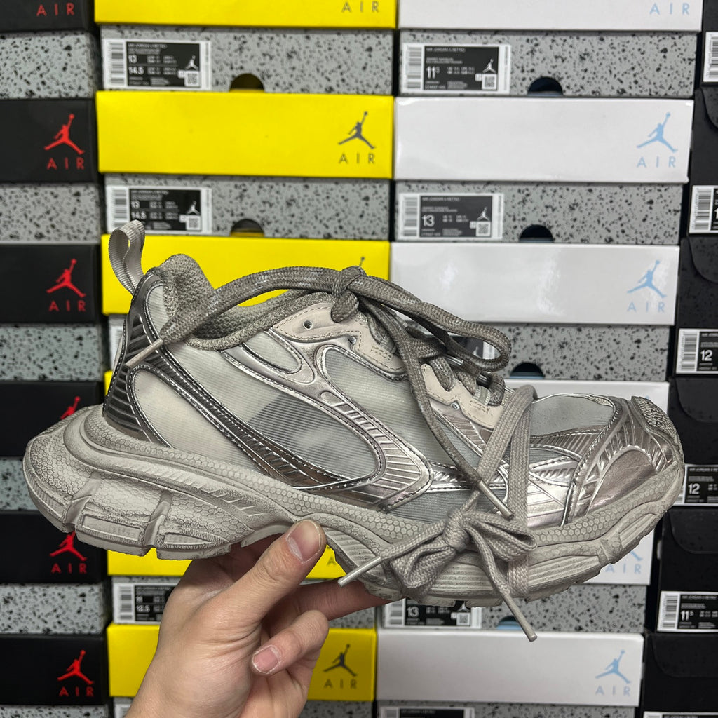 Balenciaga unisex gray sneaker with lace-up front and textured rubber sole.